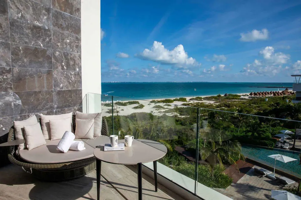 Loft Suite terrace seating with ocean view at TRS Coral Hotel.