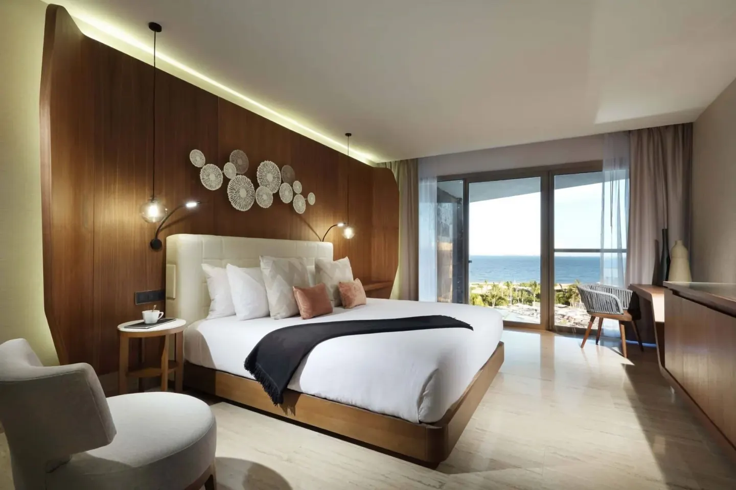 Loft Suite Ocean View bedroom with king bed and balcony view at TRS Coral Hotel.