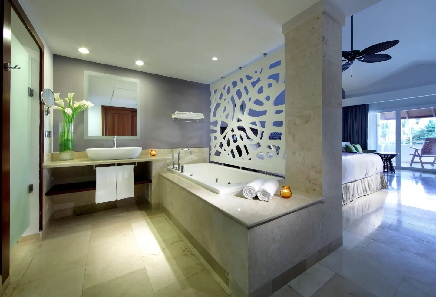 Guest room bathroom with soaking tub and bedroom beyond at TRS Turquesa Hotel.