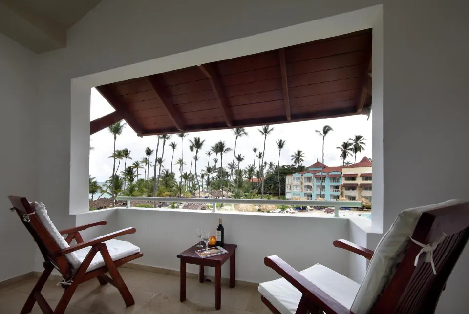 Junior Suite Garden Pool View balcony with chairs and palm views at TRS Turquesa Hotel.