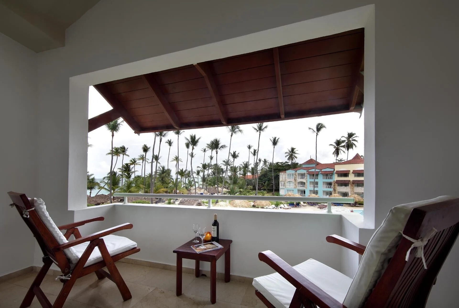 Junior Suite Garden Pool View balcony with chairs and palm views at TRS Turquesa Hotel.