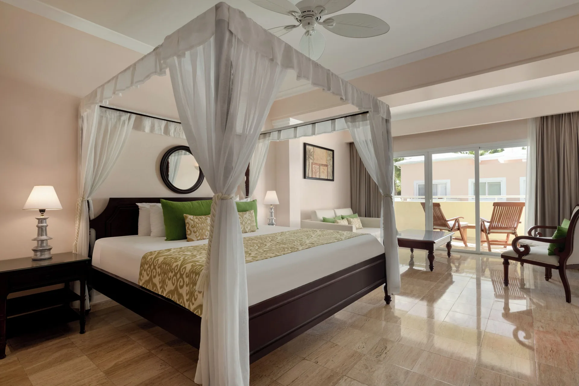Junior Suite Garden Pool View canopy bed and balcony seating at TRS Turquesa Hotel.