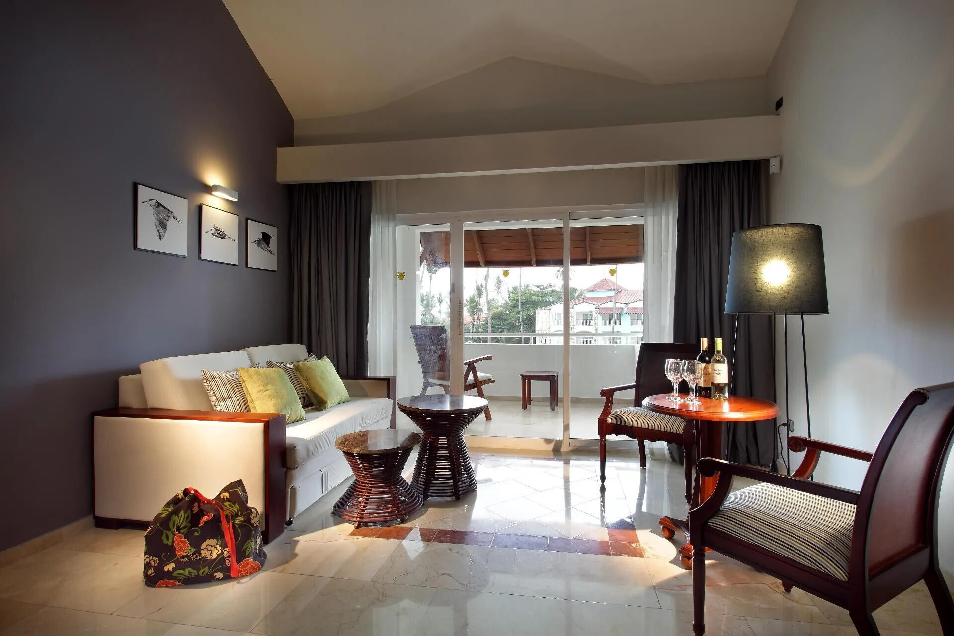 Junior Suite Garden Pool View sitting area with sofa and balcony doors at TRS Turquesa Hotel.