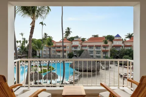 Junior Suite Poolside balcony with chairs overlooking the pool at TRS Turquesa Hotel.