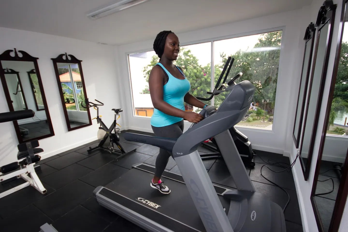 A guest uses a treadmill in the fitness room at True Blue Bay Resort.
