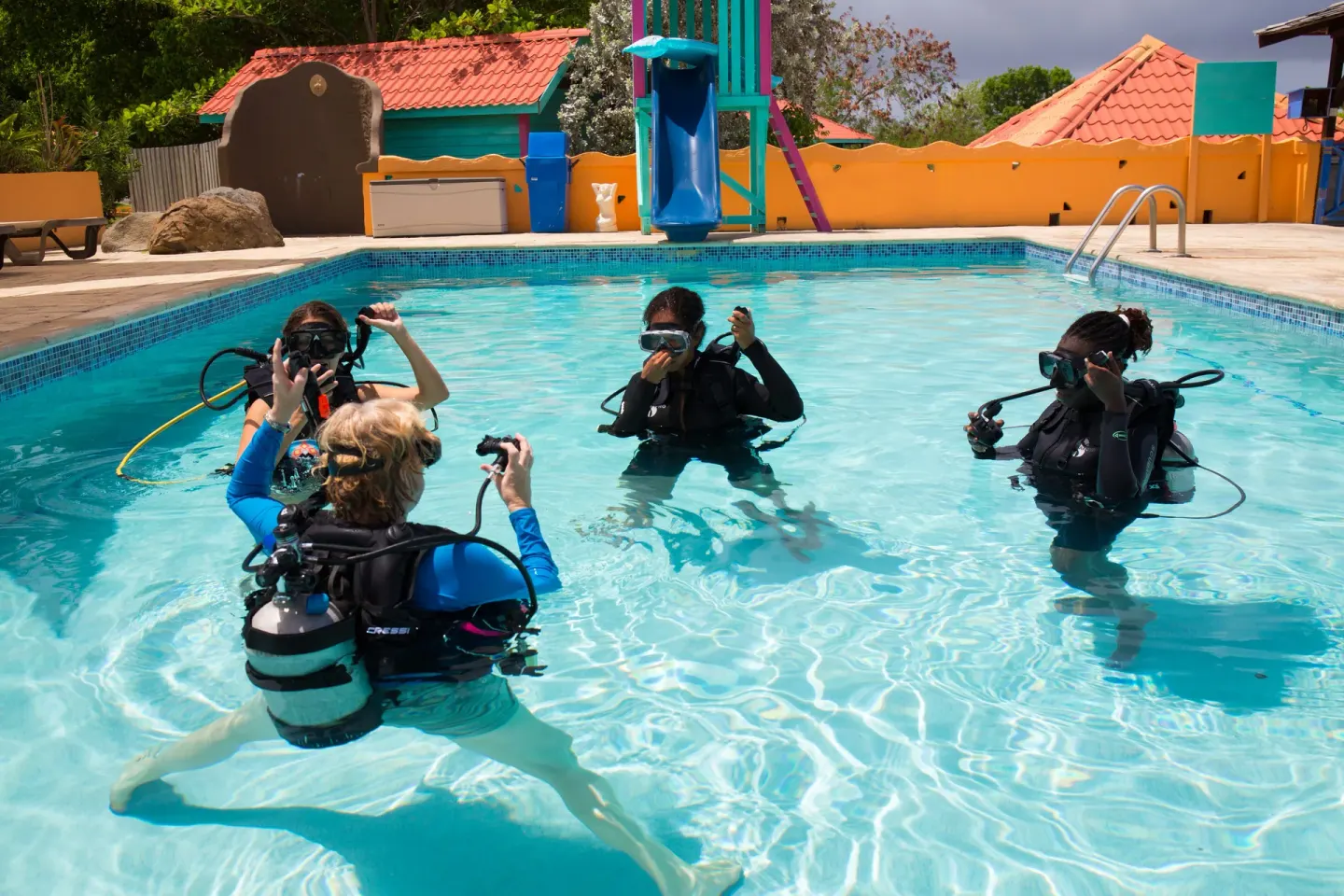 Divers practice scuba skills in a swimming pool at True Blue Bay Resort.