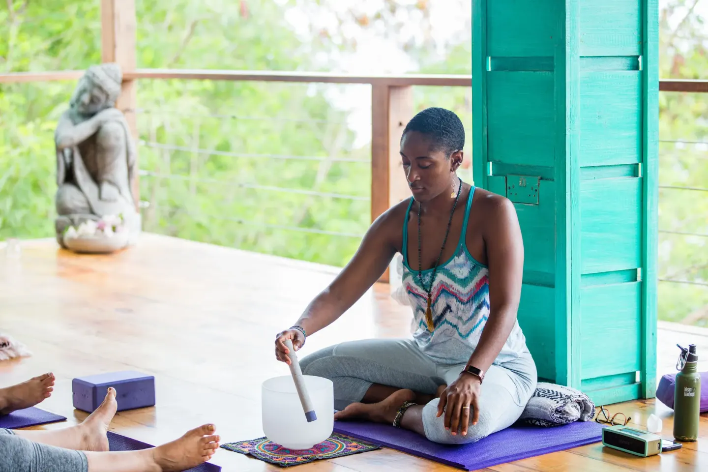 Sound bowl session in an open yoga pavilion at True Blue Bay Resort.