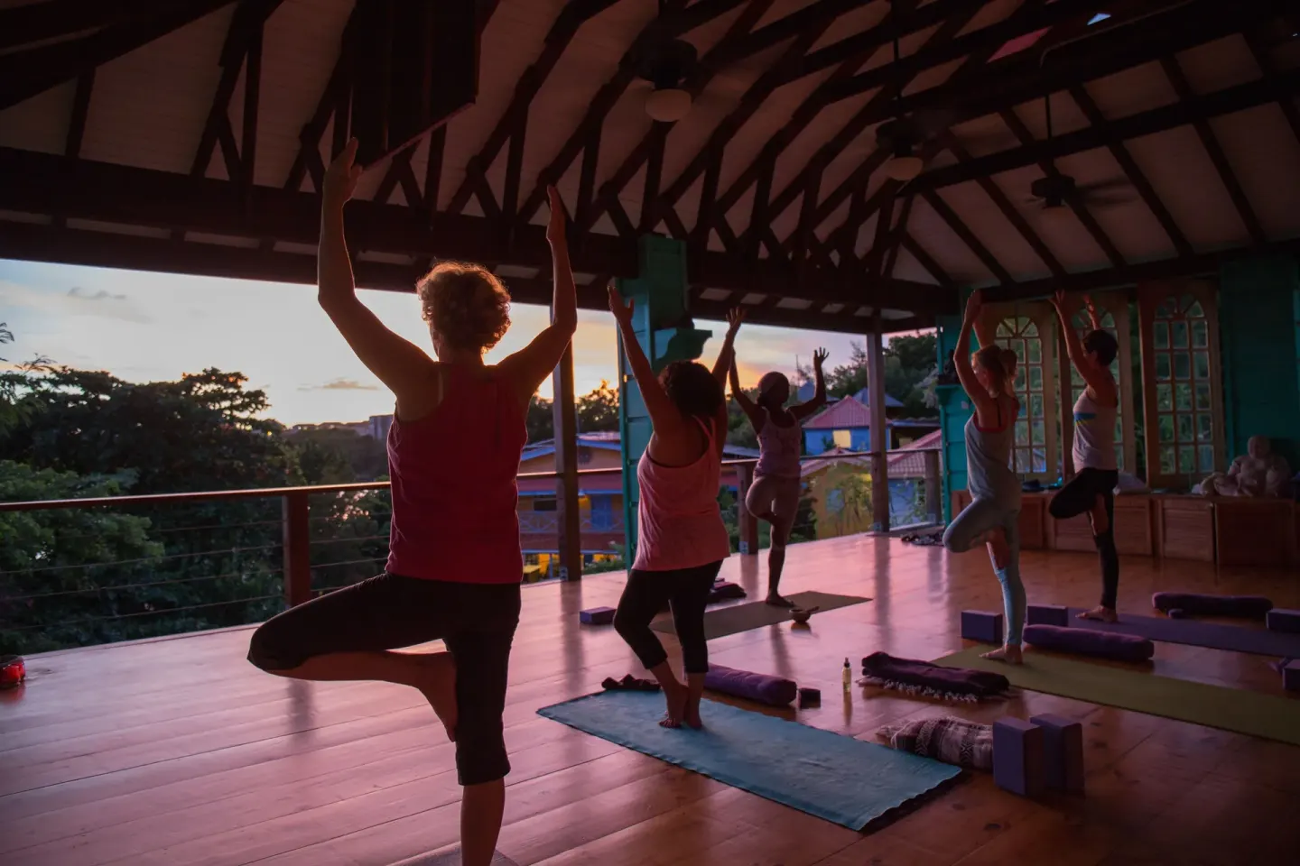 Guests practice yoga in an open-air studio at sunset at True Blue Bay Resort.