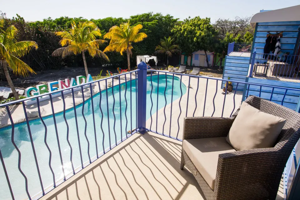 Cocoa Pod Room balcony overlooking the pool at True Blue Bay Resort.