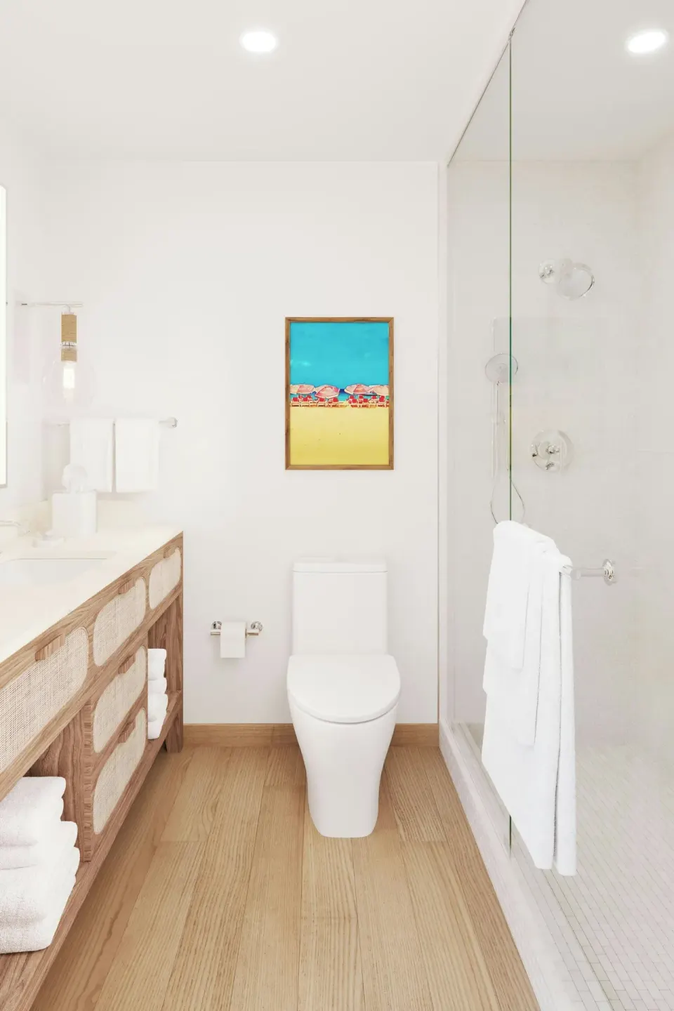 Bright bathroom with wood vanity, toilet and glass shower at Turtle Beach.