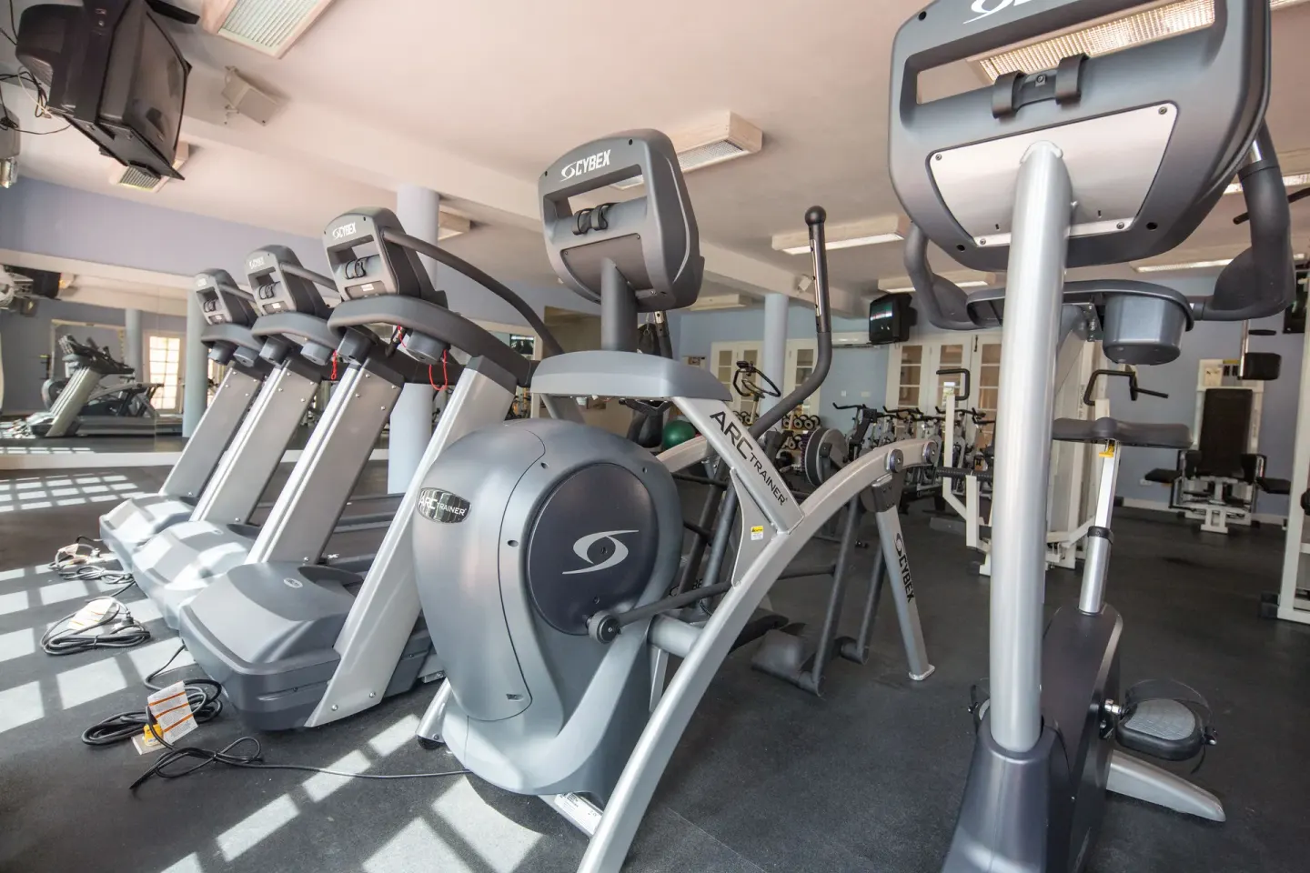Fitness room with treadmills, cardio machines, and weights at Turtle Beach.