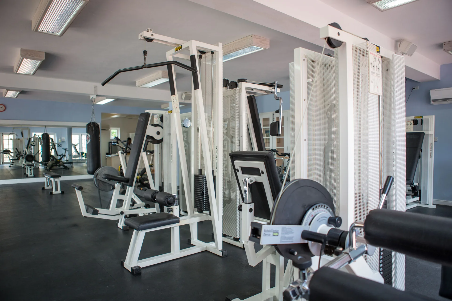 Fitness room weight machines and mirrors inside Turtle Beach.