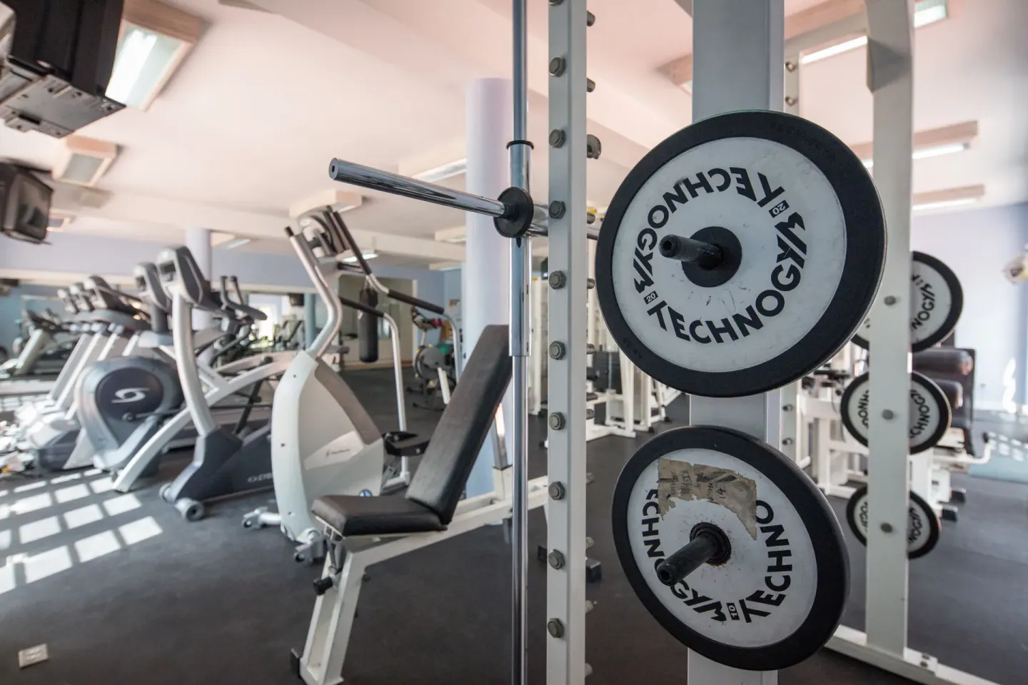 Gym weight plates and exercise machines in the fitness room at Turtle Beach.