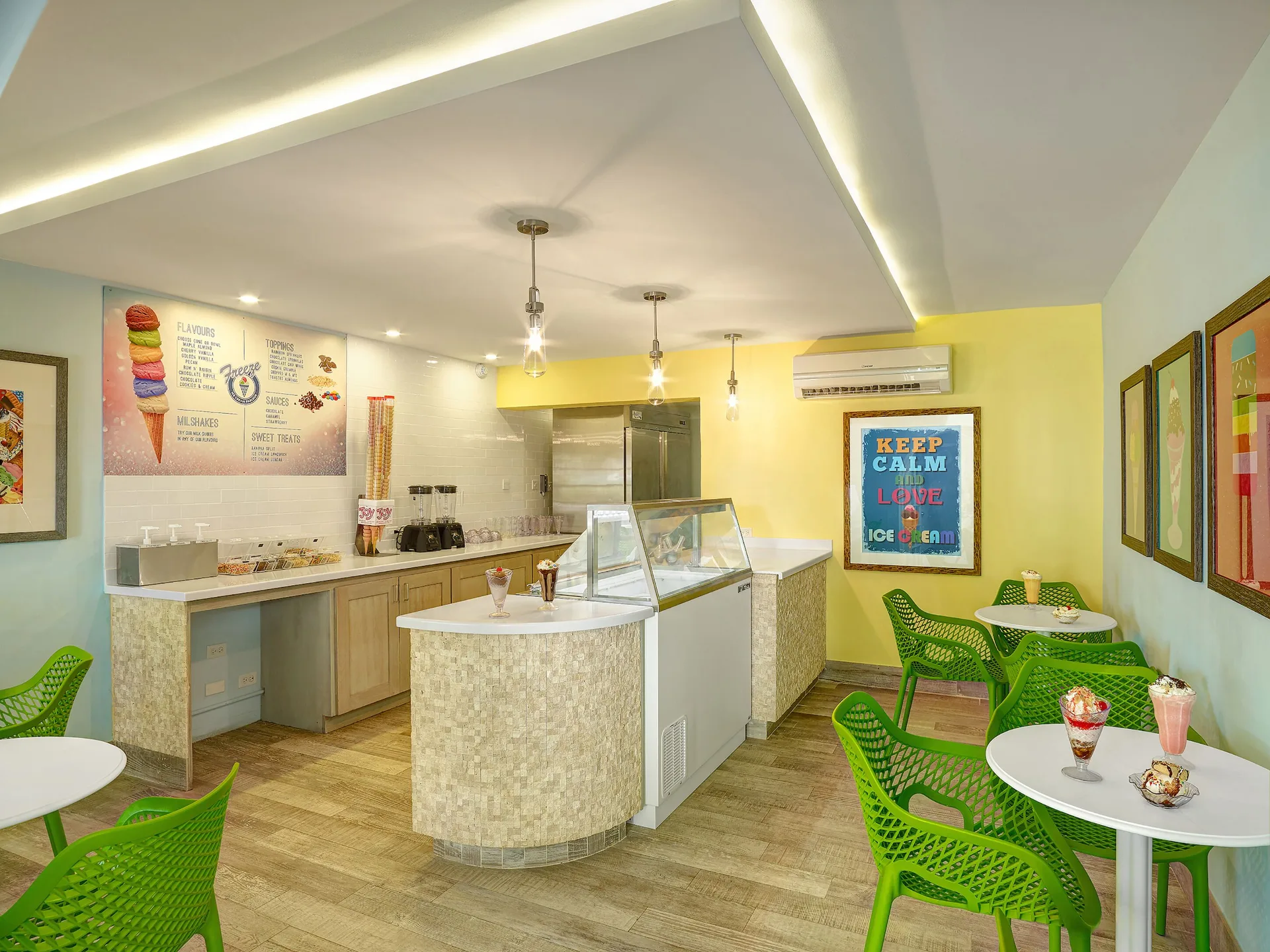 Ice cream shop with green chairs and dessert displays at Turtle Beach.