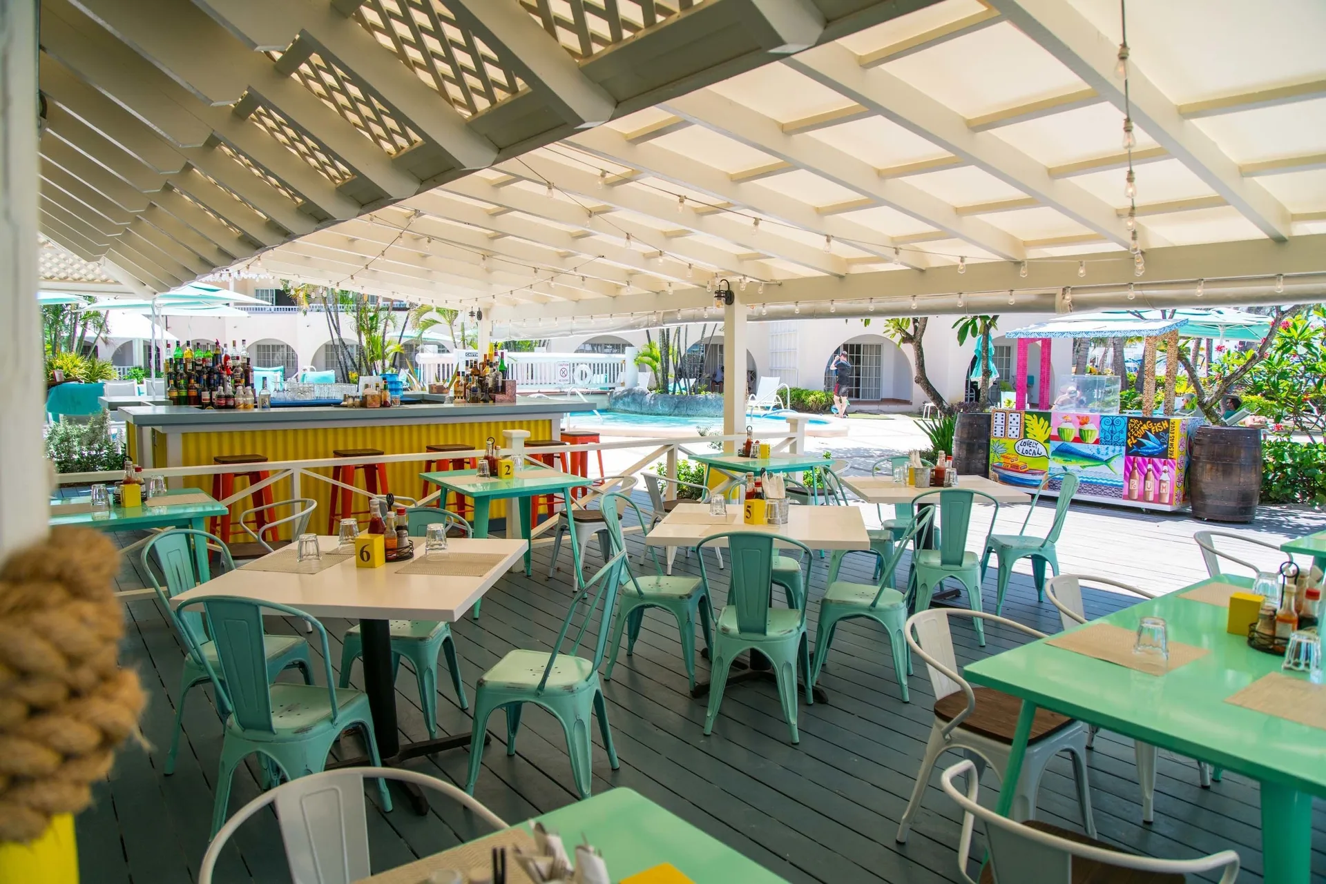 Open-air bar and dining area beside the pool at Turtle Beach.