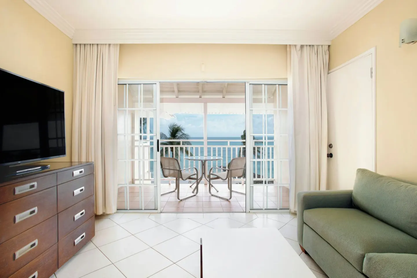 Sitting area in a Junior Suite ocean view room at Turtle Beach opening to a balcony.