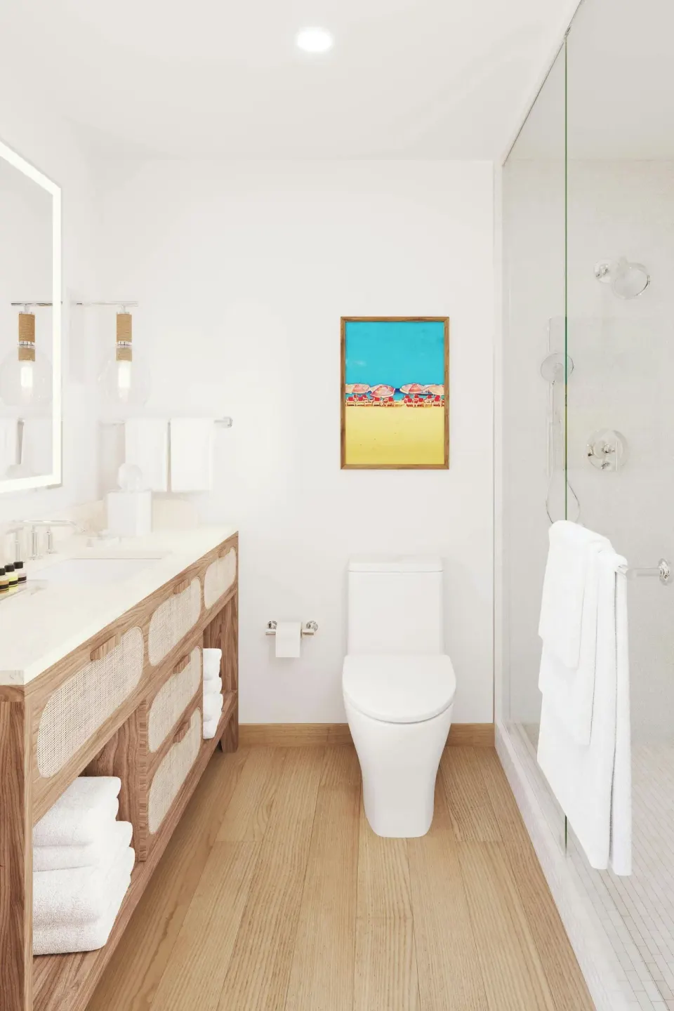Bright bathroom with vanity, toilet, and glass shower in a suite at Turtle Beach.