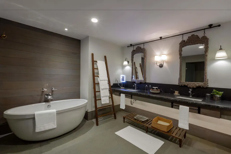 Freestanding bathtub and double vanity in a bathroom at Unico Hotel Riviera Maya