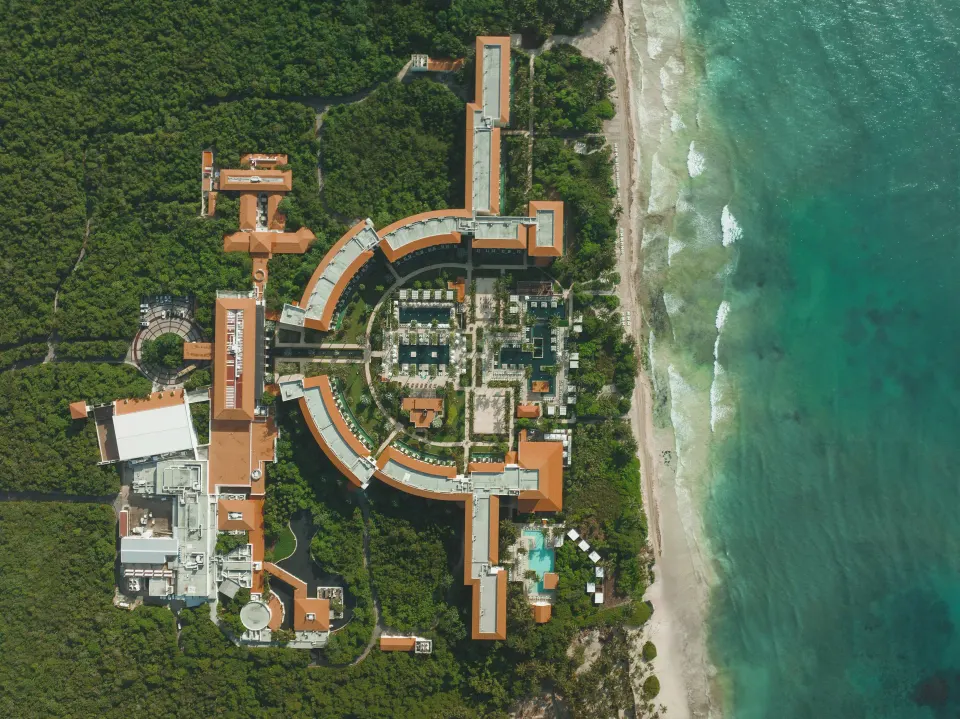 High-altitude overhead image of the Unico Hotel Riviera Maya property next to the beach