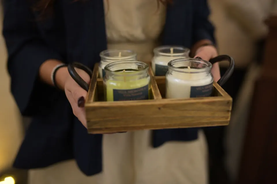 Tray of four small scented jars held by staff at Unico Hotel Riviera Maya