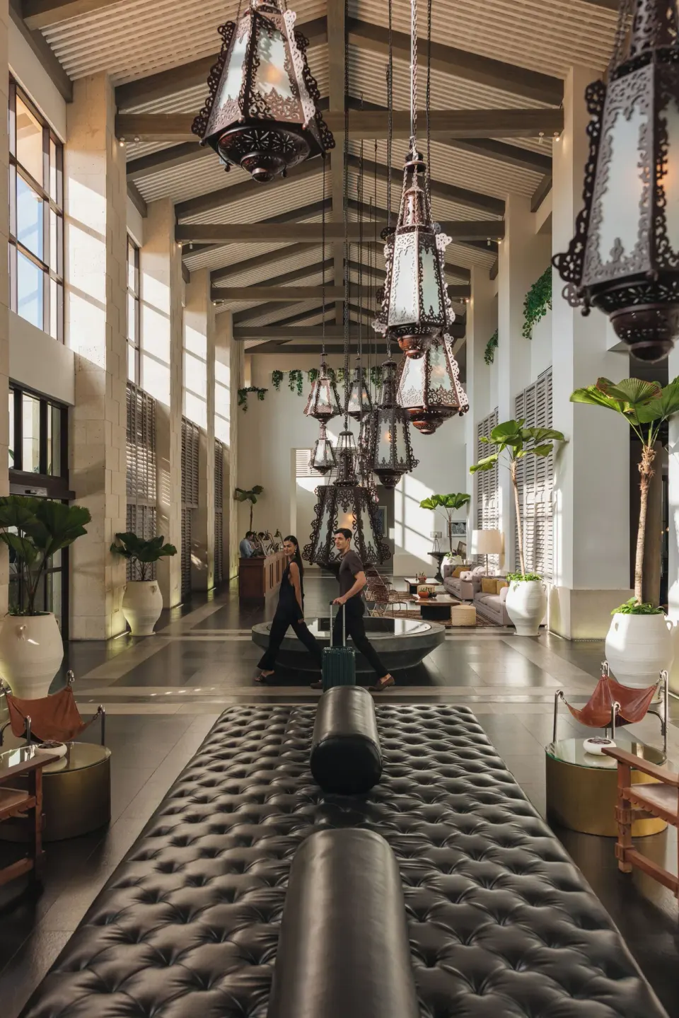 Lobby interior with tufted bench and seating area at Unico Hotel Riviera Maya