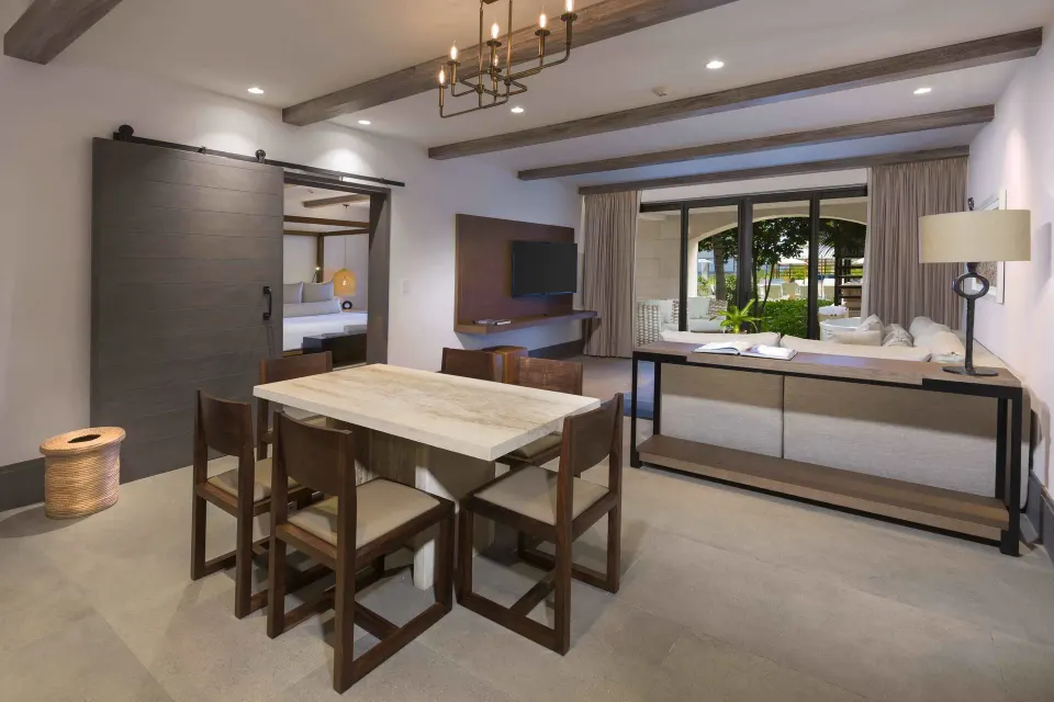 Dining area and living space in a resort suite at Unico Hotel Riviera Maya