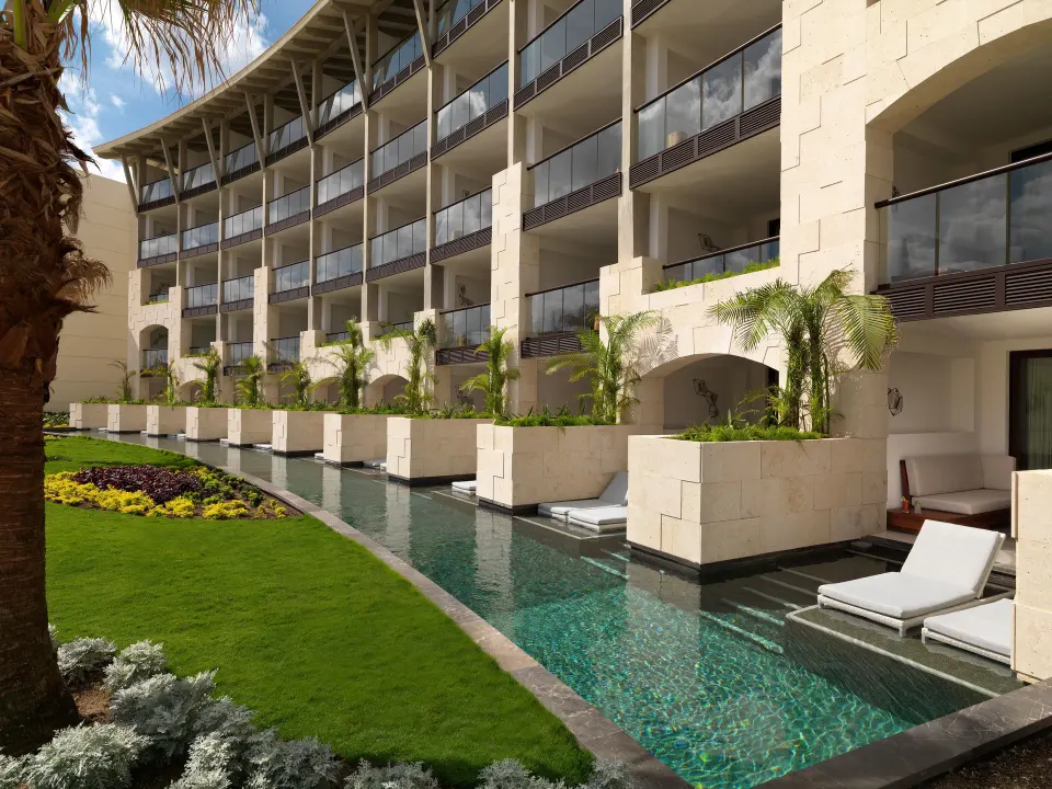 Resort building with swim-up terrace rooms and private plunge pools at Unico Hotel Riviera Maya