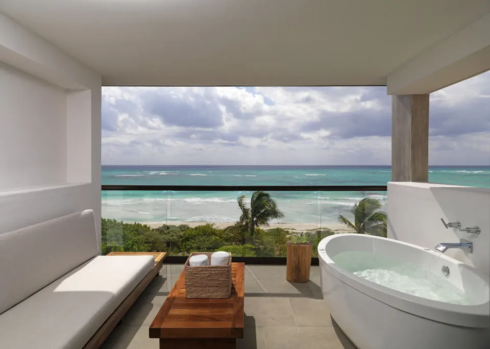 Ocean-view terrace with freestanding tub and bench at Unico Hotel Riviera Maya