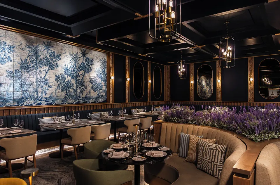 Upscale dining room with curved banquette and floral centerpiece at Unico Hotel Riviera Maya