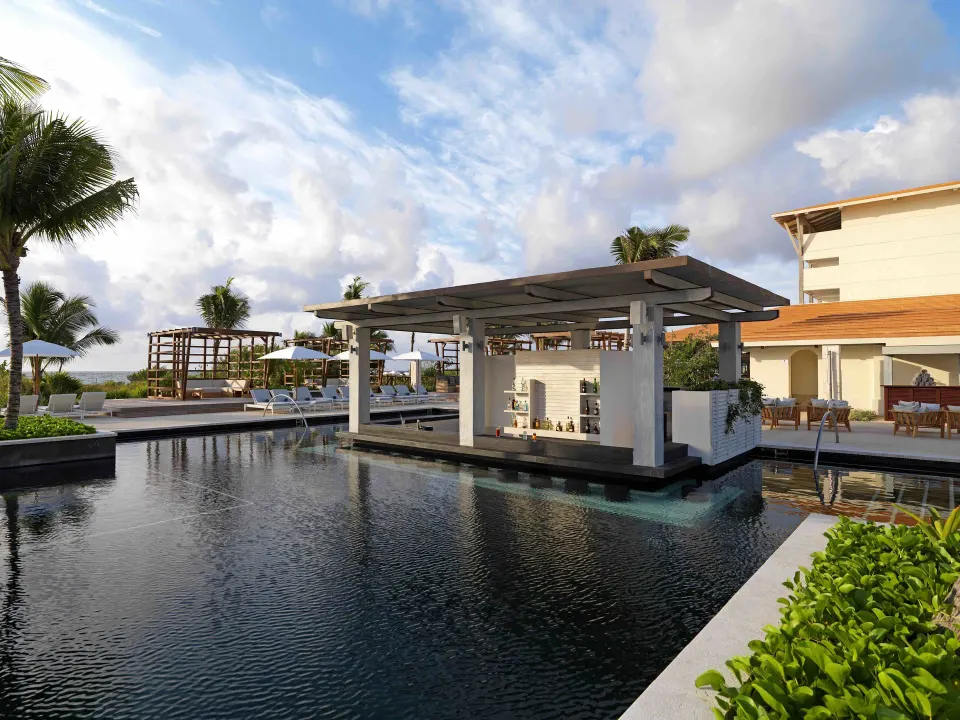 Swim-up pool bar structure over water at Unico Hotel Riviera Maya.