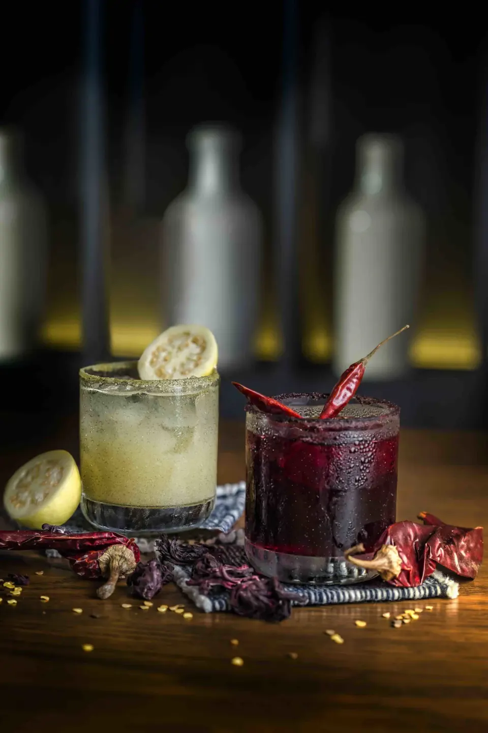 Two craft cocktails garnished with citrus and chilies at Unico Hotel Riviera Maya