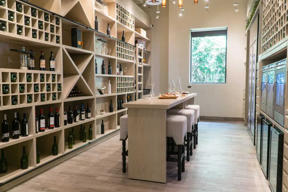 Wine tasting room with wall racks and central tasting table at Unico Hotel Riviera Maya