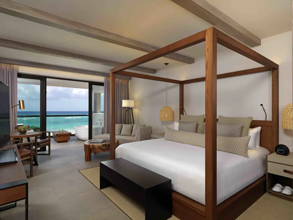 Alcoba Ocean Front Room king bed facing balcony and outdoor tub at Unico Hotel Riviera Maya