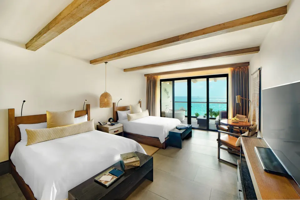 Alcoba Ocean Front Room twin beds with balcony and ocean view at Unico Hotel Riviera Maya