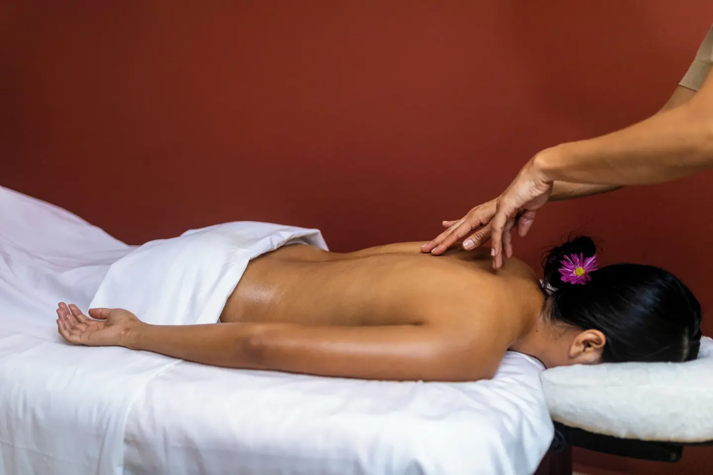 A guest receives a back massage in a spa room at Valentin Imperial Riviera Maya.