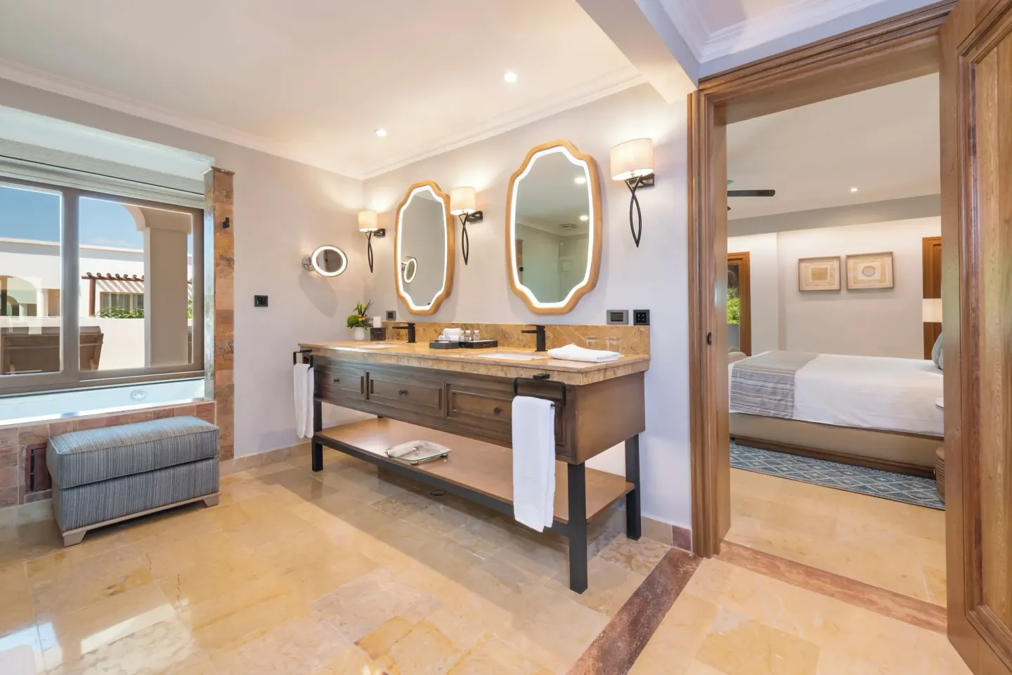 Bathroom vanity and bedroom doorway in a suite at Valentin Imperial Riviera Maya.