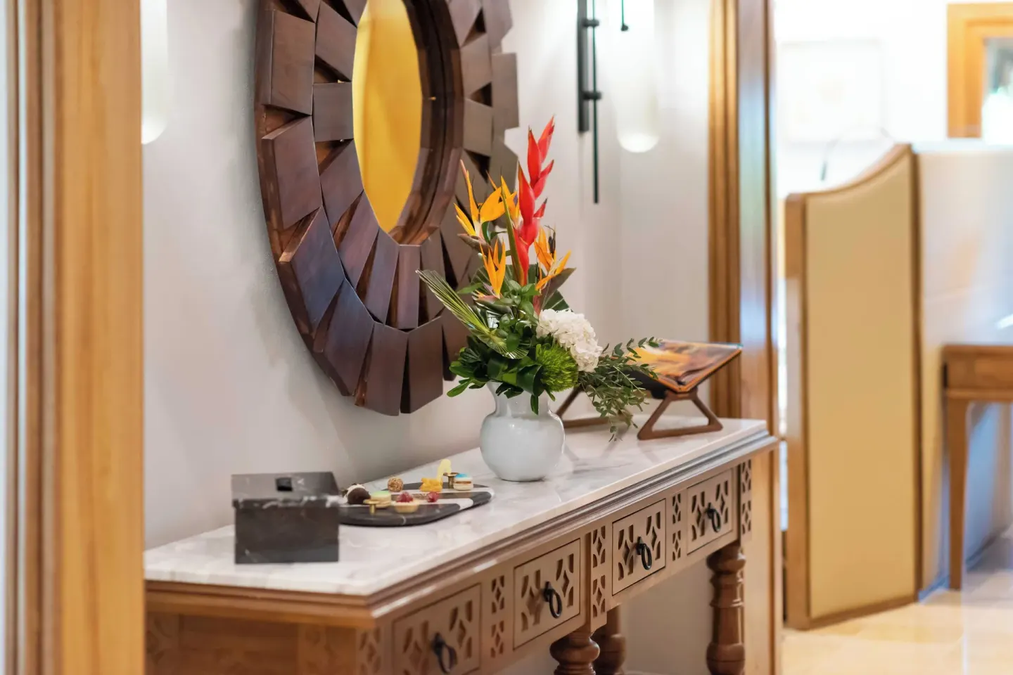 Suite console with flowers and wall mirror at Valentin Imperial Riviera Maya.