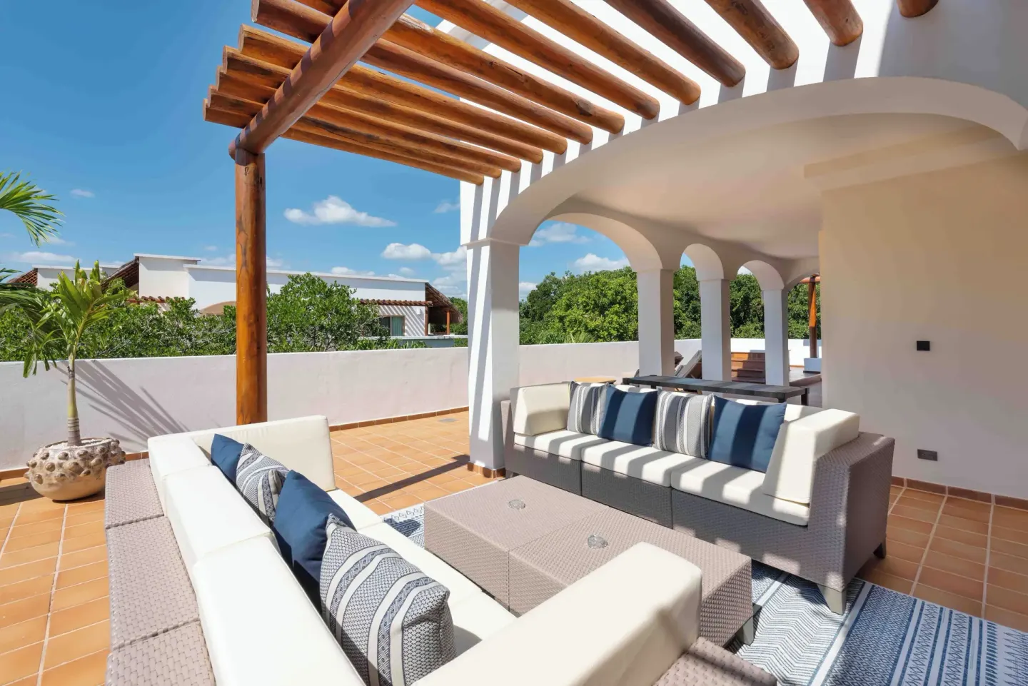 Shaded terrace seating under a wood pergola at Valentin Imperial Riviera Maya.