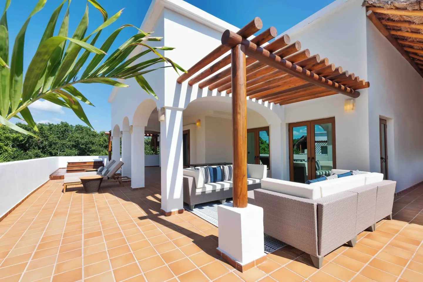 Large terrace with sofas and loungers at Valentin Imperial Riviera Maya.