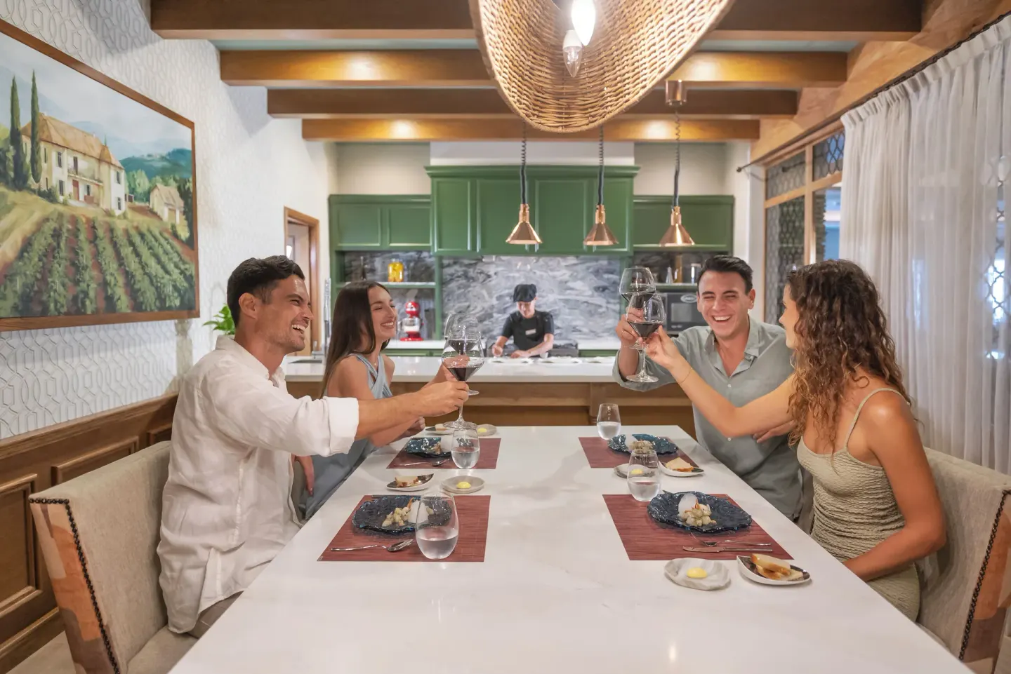 Guests toasting wine at a chef's table at Valentin Imperial Riviera Maya.