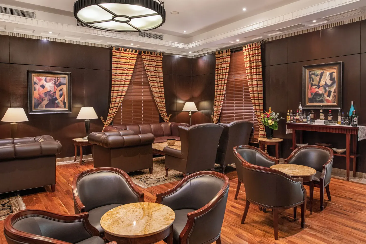 Leather seating and a spirits bar in a cigar lounge at Valentin Imperial Riviera Maya.