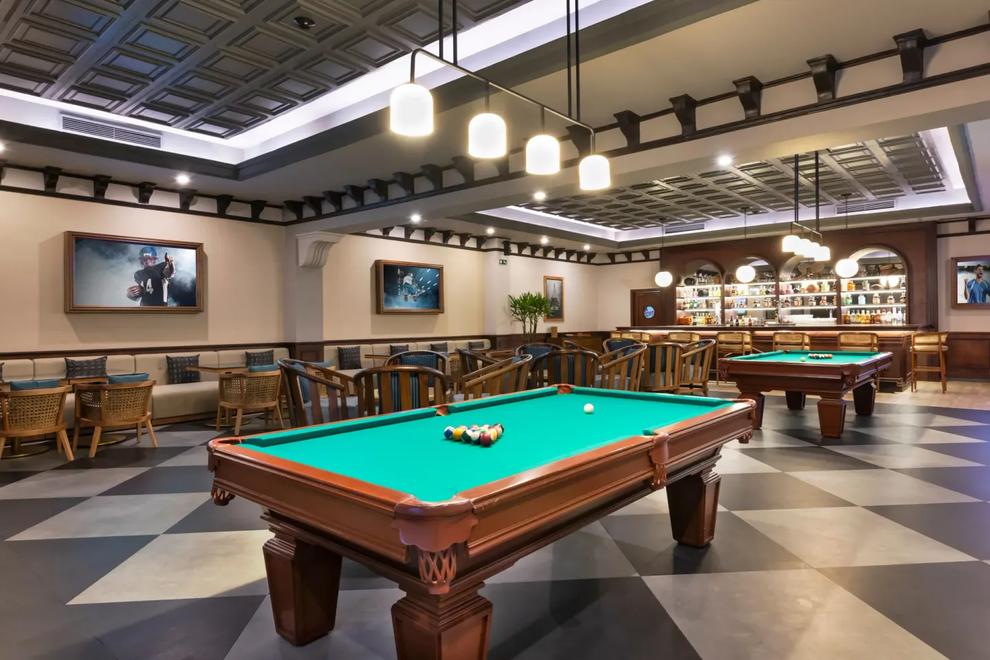 Billiards tables and bar shelves inside Sports Bar at Valentin Imperial Riviera Maya.