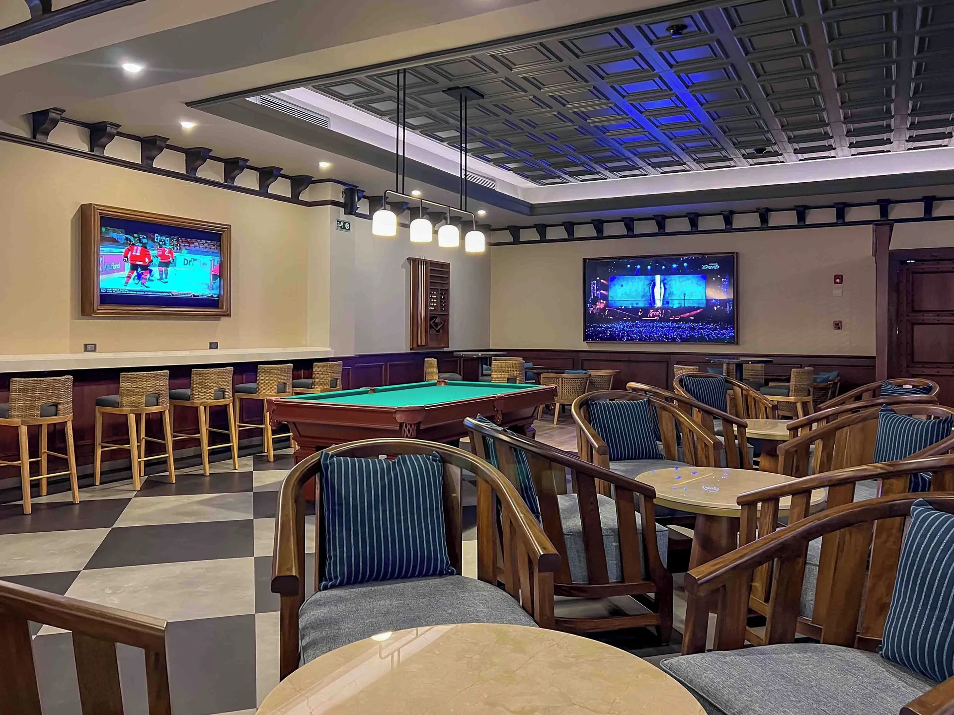 Sports bar lounge with pool table and TVs at Valentin Imperial Riviera Maya.
