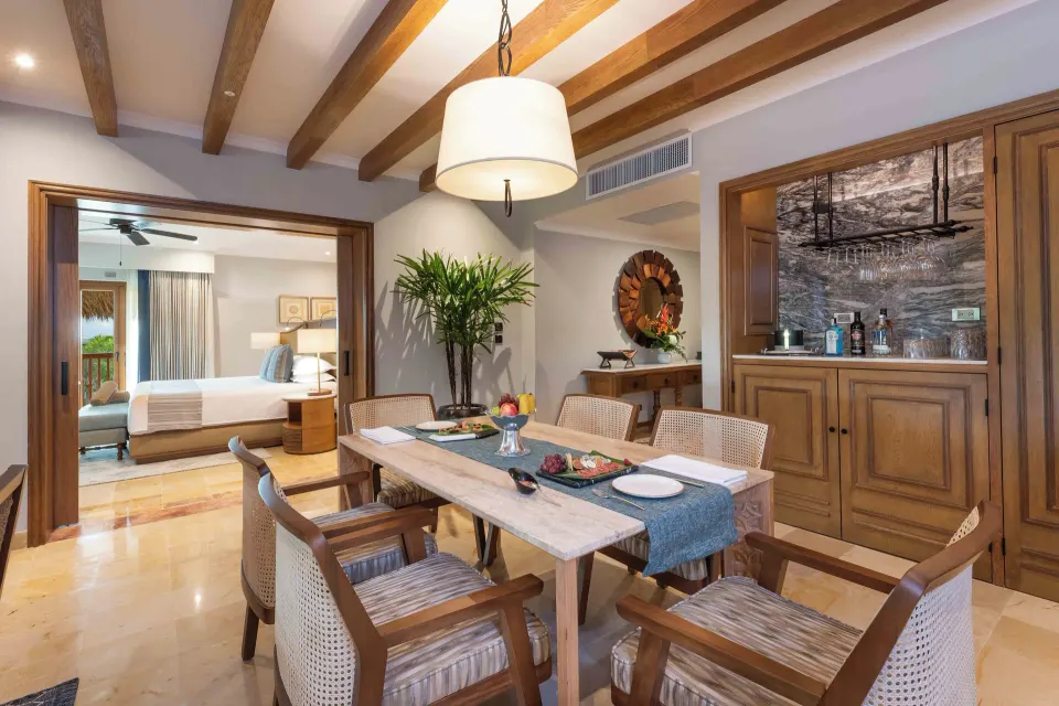 Diamond Suite dining room with bedroom beyond at Valentin Imperial Riviera Maya.
