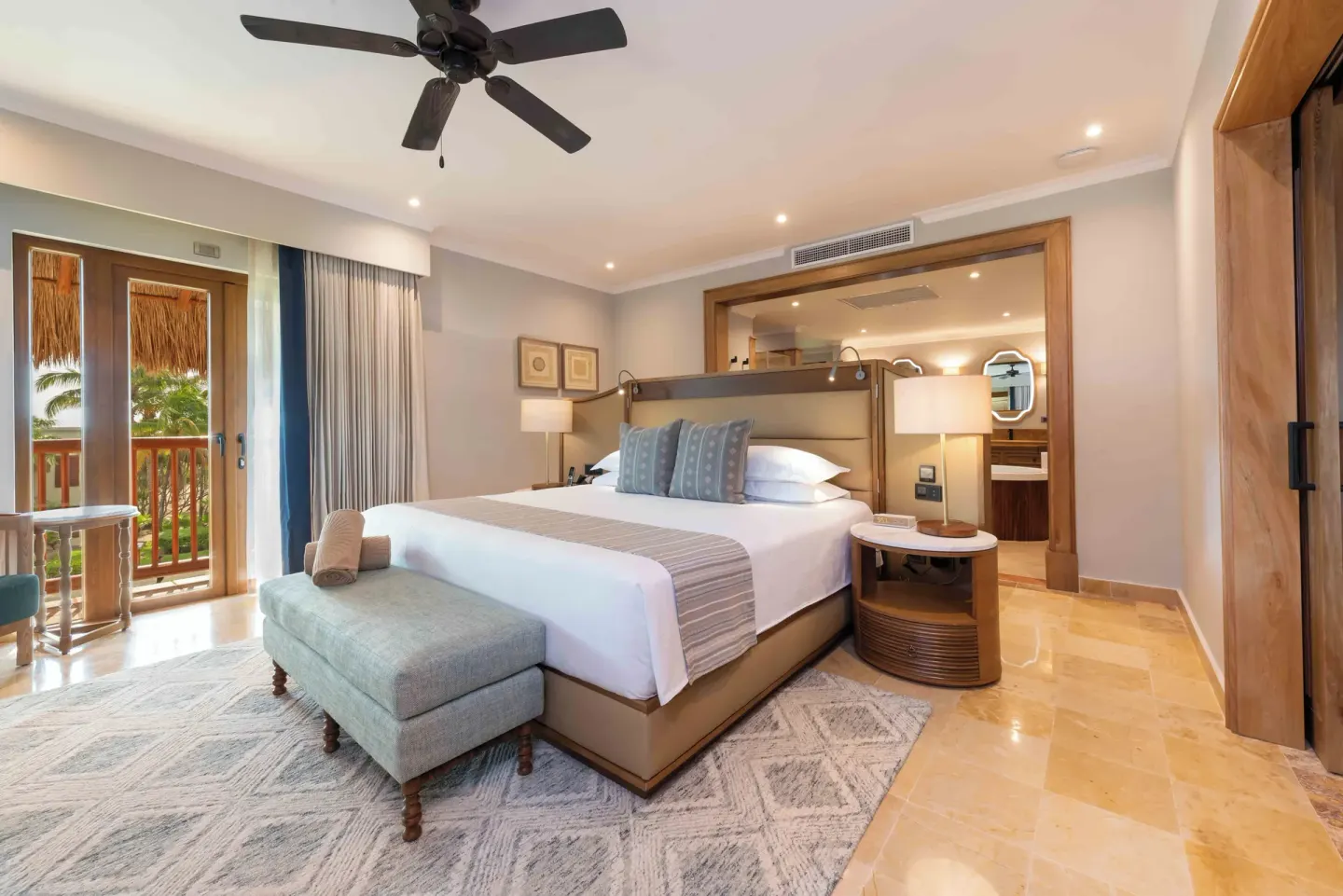 Diamond Suite king bed with bench and open bathroom at Valentin Imperial Riviera Maya.