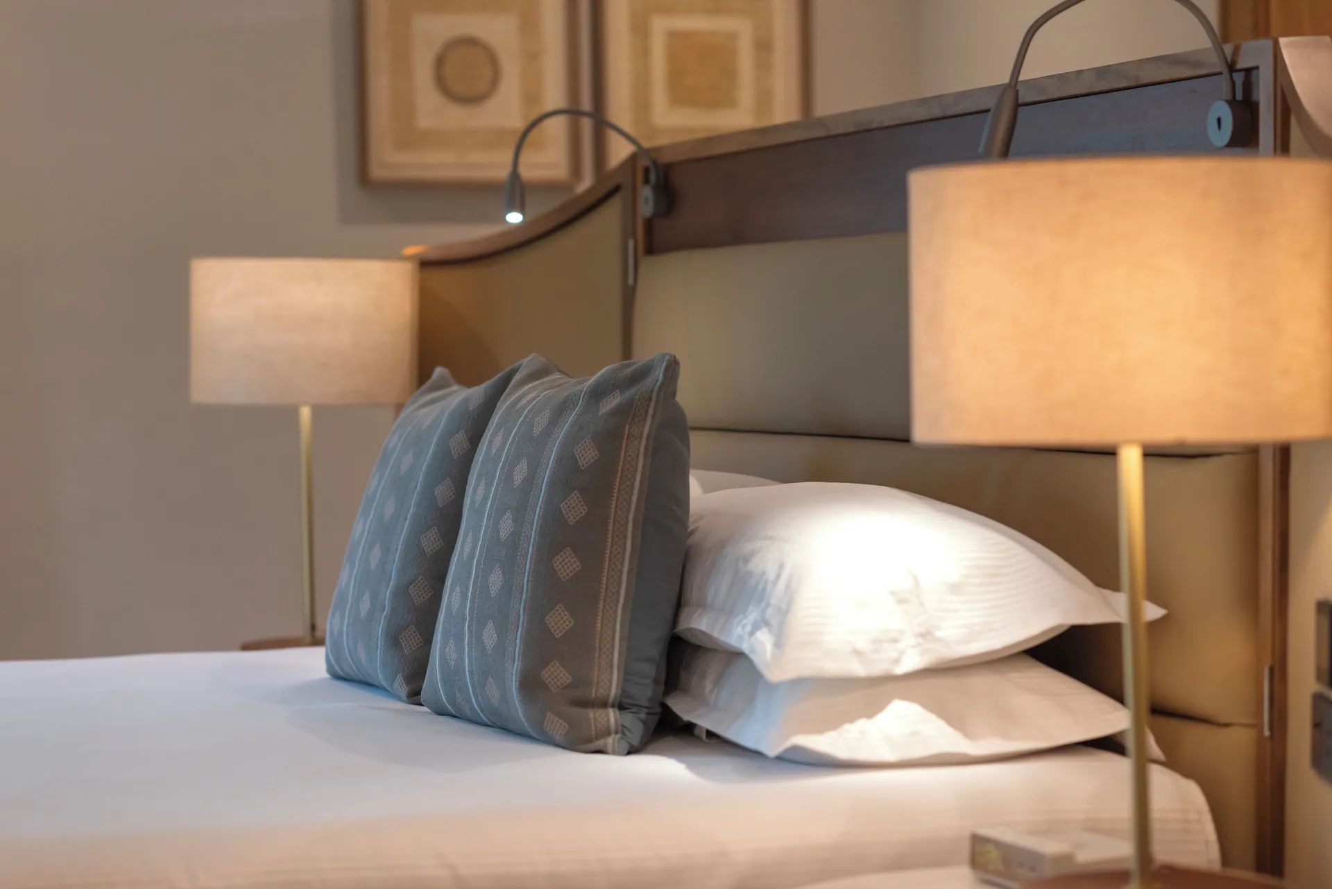 Diamond Suite bed with pillows and reading lamps at Valentin Imperial Riviera Maya.