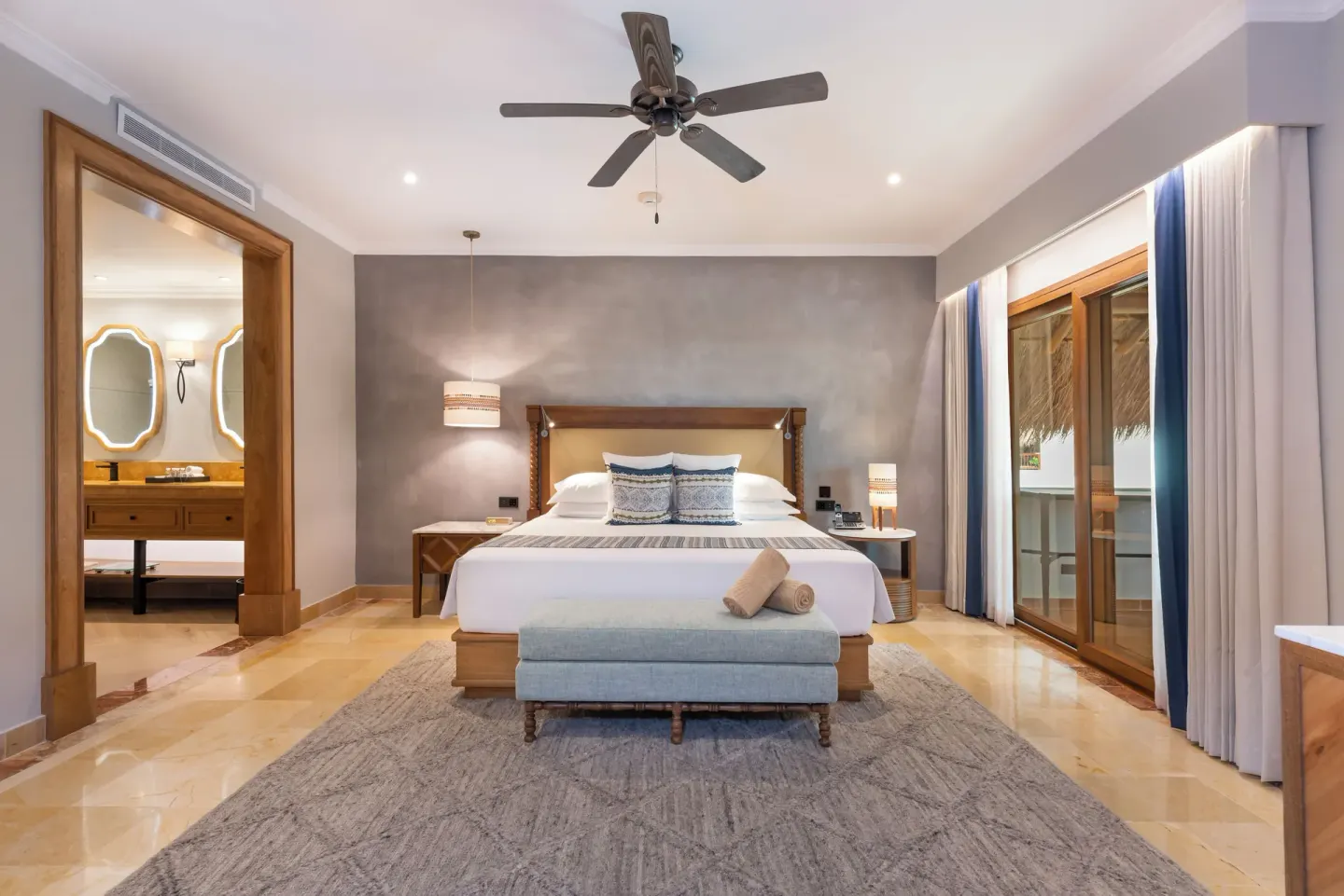 Diamond Suite king bed with balcony doors and bathroom entry at Valentin Imperial Riviera Maya.
