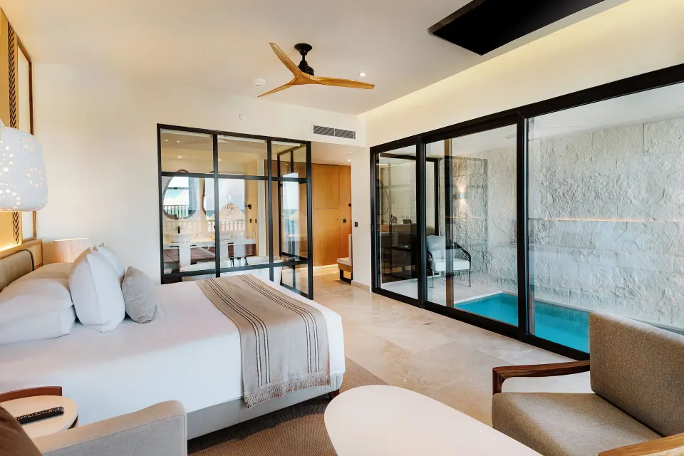 Dunas Private Pool Ocean View Suite bed beside private indoor pool at Valentin Imperial Riviera Maya.