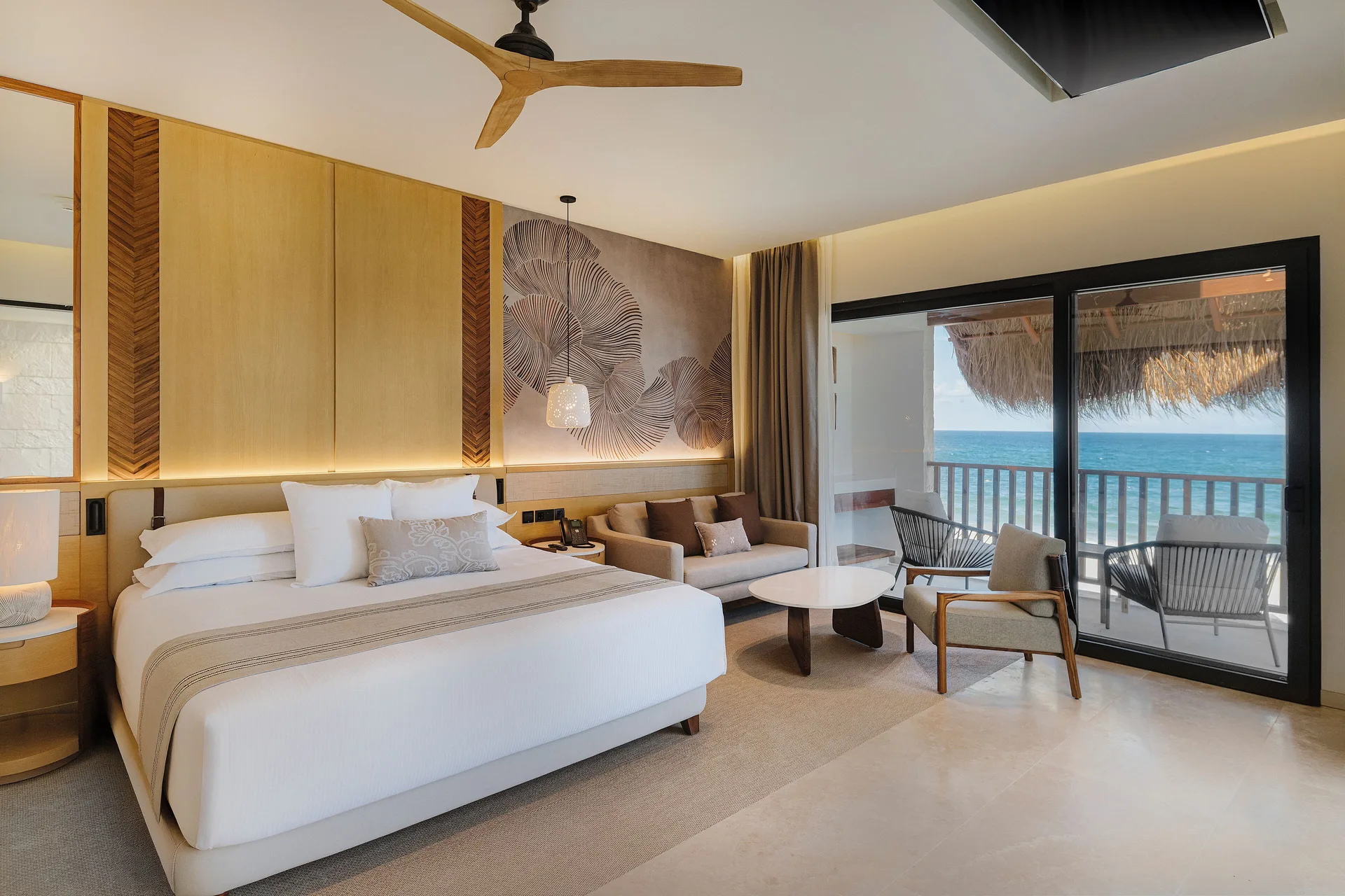 Dunas suite bedroom with ocean-view balcony at Valentin Imperial Riviera Maya.
