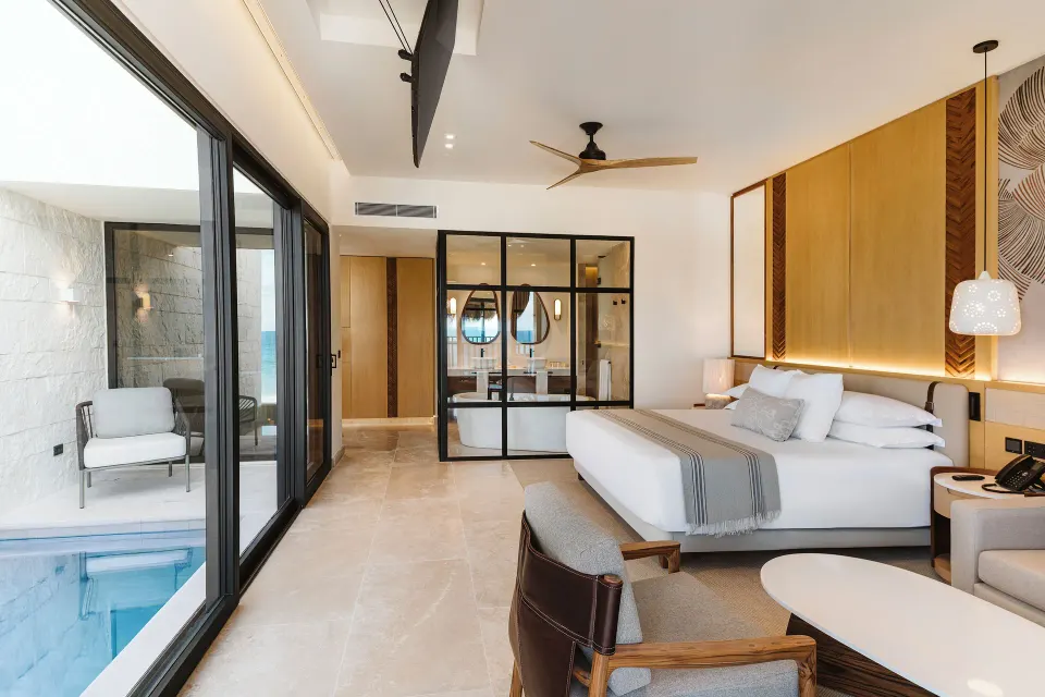 Dunas suite bedroom with glass bath and private pool at Valentin Imperial Riviera Maya.